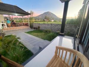 a porch with a bench and a view of a mountain at Mount Batur Homestay in Kubupenlokan