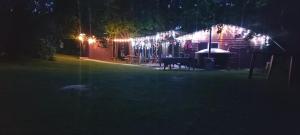 a house lit up at night with lights on it at Pirts,kubls,,Saknēs,, in Talsi