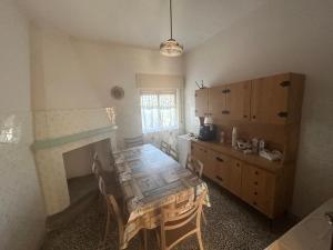 a kitchen with a table and a dining room at Masseria Novelli in Cassano Jonio