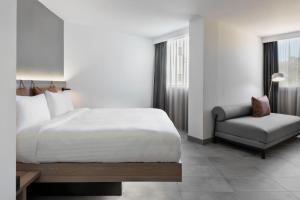 a hotel room with a bed and a chair at Moxy La Ciotat in La Ciotat
