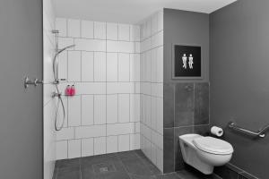 a bathroom with a shower and a toilet in it at Moxy La Ciotat in La Ciotat