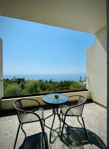 a table and two chairs on a balcony with a view at Gogo's Boutique Hotel in Dhërmi +123 photos