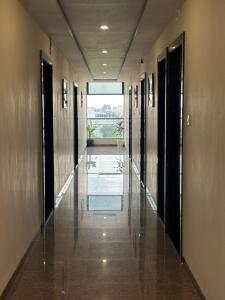 a hallway of a building with glass doors and a hallwayngth at Hotel Dream Inn in Mānglia
