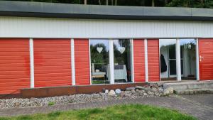 a building with red and white doors and windows at Strandhaus in Heringsdorf +12 photos