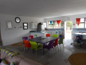 a kitchen with a table and chairs in a room at Lala Kahle in Sodwana Bay