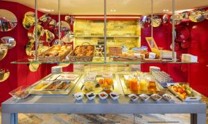 a bakery with a display case filled with lots of pastries at Swiss Wine by Fassbind in Lausanne