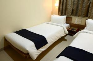 Postel nebo postele na pokoji v ubytování Hotel Matrix Inn Chakan