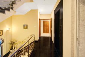 a hallway of a building with stairs and a door at Super Townhouse 1374 Hotel LFC in Jaipur