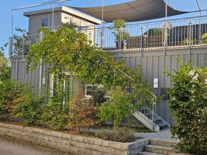 a house with a staircase in front of it at Haus zur Aach Tinyhouse in Uhldingen-Mühlhofen