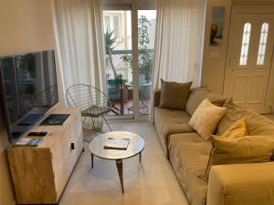a living room with a couch and a tv at Casa Argento in Zakynthos Town