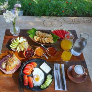 a breakfast table with a plate of breakfast foods and drinks at Hotel Ballkan Shkoder in Shkodër
