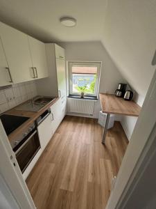 a small kitchen with a table and a window at Margarethe in Süderlügum