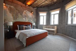 a bedroom with a large bed in a room with windows at Stunning 6BR 4Bath near Tram in Istanbul