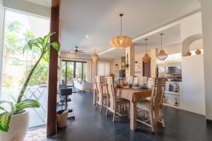 a kitchen and dining room with a table and chairs at Villa GMT Canggu - By Bali Lyfe Venture in Canggu