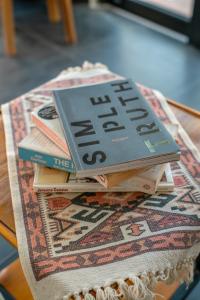 a stack of books sitting on top of a table at Villa GMT Canggu - By Bali Lyfe Venture in Canggu