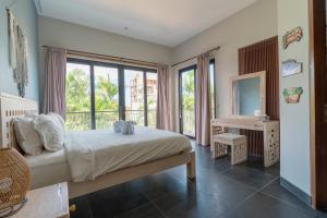a bedroom with a bed and a large window at Villa GMT Canggu - By Bali Lyfe Venture in Canggu +101 photos