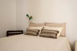 a white bed with two pillows on top of it at Mava' - Splendida struttura nel centro storico di Fasano in Fasano