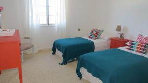 a hotel room with two beds and a window at Salt Water Villa in Santa Cruz +35 photos