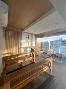 a room with benches and a table and a balcony at Casa Mira Guadalupe Harmony Home Cebu City in Cebu City