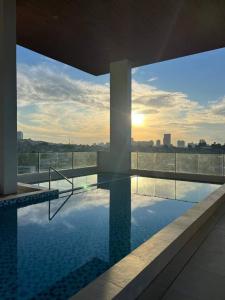 a swimming pool on the roof of a building at Casa Mira Guadalupe Harmony Home Cebu City in Cebu City