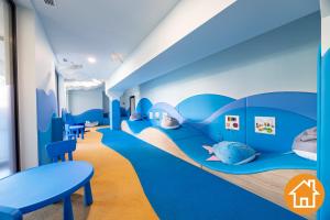 a childrens room with blue walls and blue beds at Apartamenty Baltic Waves - visitopl in Międzyzdroje +50 photos