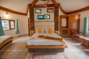 a bedroom with a bed in a room at La Perle River Resort By Excel Hotels & Resorts in Rāmnagar +56 photos