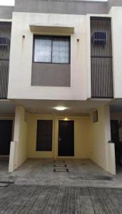 a large building with a door and two windows at Mactan Guesthouse in Cogon