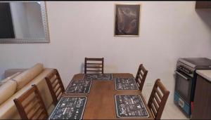 a dining room table with chairs and a couch at Mactan Guesthouse in Cogon +1 photo