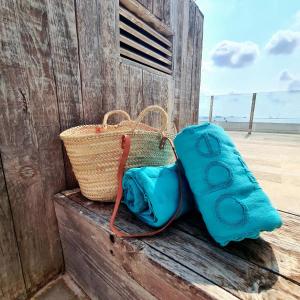 a blue bag and a basket on a wooden wall at Apartamentos Llobet Ibiza in Ibiza Town