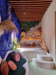 a bedroom with a bed and stairs in a room at Casa Amina in Chefchaouene