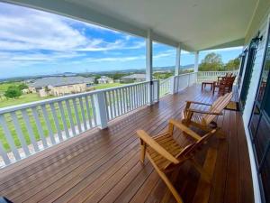 a deck with chairs and tables on a balcony at Stay Olive Green in Mount Marshall