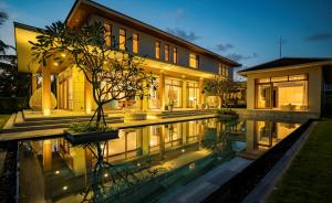 a house with a swimming pool in front of a house at Ocean Beach Resort Da Nang in Danang +39 photos