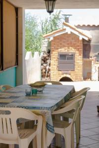 a table with chairs and a blue table cloth on it at Amaris Mango Seafront Villa in Granelli