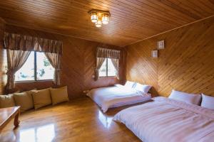 Postel nebo postele na pokoji v ubytování Chiayi Yipin Tea B&B