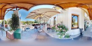 a patio with tables and umbrellas in a building at Hotel Hradna brana in Bratislava