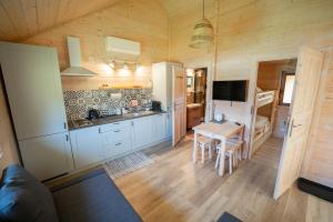 a kitchen with a table and a dining room at Domek pod Szczelińcem in Radków
