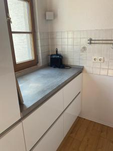 a small kitchen with a counter and a window at Ferienwohnung Nägler in Erbach