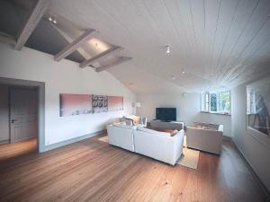 a living room with two white couches and a television at The Embassy in Lund