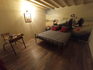 a room with a bed with a car on the wall at Le Vintage Loft Garage in Saint-Agnan-sur-Loire
