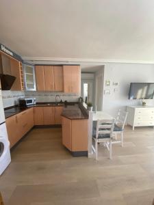 a kitchen with a table and a table and chairs at Sweet home Salou in Salou