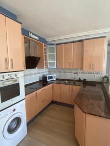 a kitchen with a washer and a sink and a dishwasher at Sweet home Salou in Salou