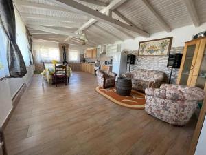 a living room with two couches and a kitchen at MOGA House in Tîrnăveni