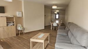 a living room with a couch and a table at Casa Rural La Nava in Navaluenga
