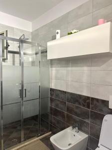 a bathroom with a shower and a toilet and a sink at Glenis Apartment Vollga in Durrës +26 photos