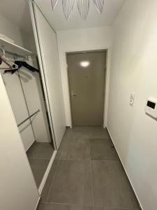 a hallway with a door and a tile floor at Grand Studio in Ajaccio