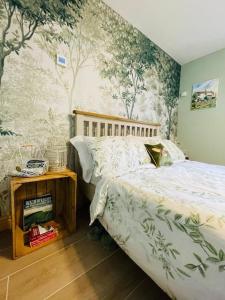 a bedroom with a bed and trees on the wall at Westwood Farm in Kirkby Stephen +23 photos