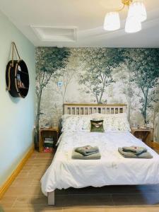 a bedroom with a bed with a floral wall at Westwood Farm in Kirkby Stephen