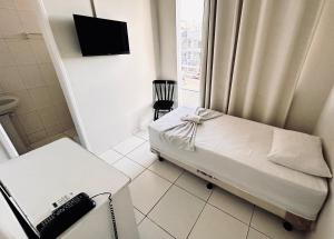 a hospital room with a bed and a phone at POUSADA MEDITERRÂNEO in Lagarto