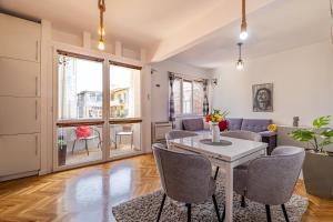 a living room with a table and chairs at Apartment DOLCE CASA in Varna City