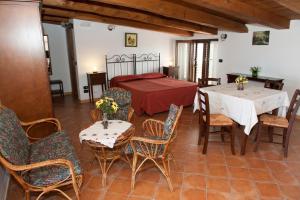 a living room with a bed and tables and chairs at Casa Vacanze - Affittacamere Il Tempone in Prignano Cilento